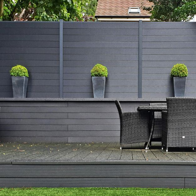 Charcoal Composite Fencing situated behind a raised decking platform.