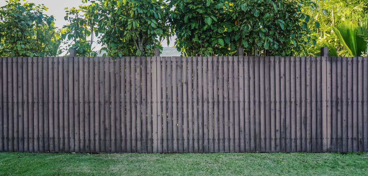 An uneven traditional wooden fence with individual panels.