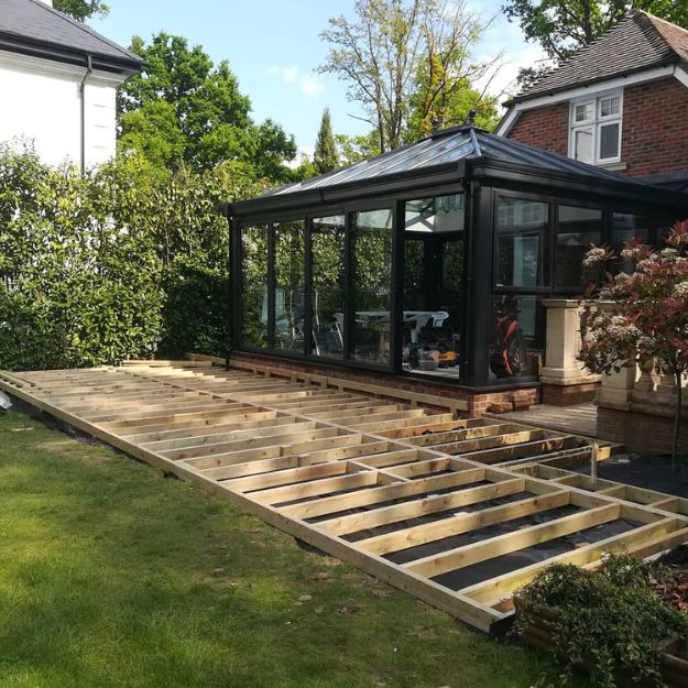 Timber decking base next to a conservatory