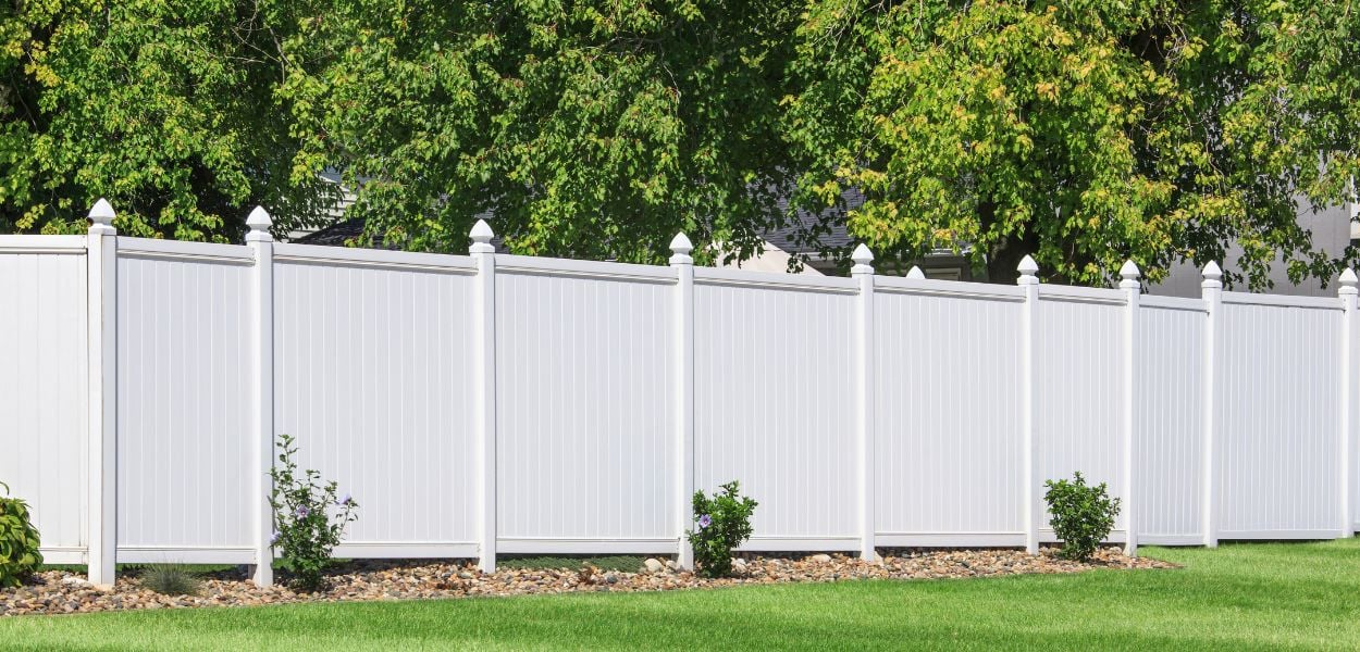 white vinyl fence in garden