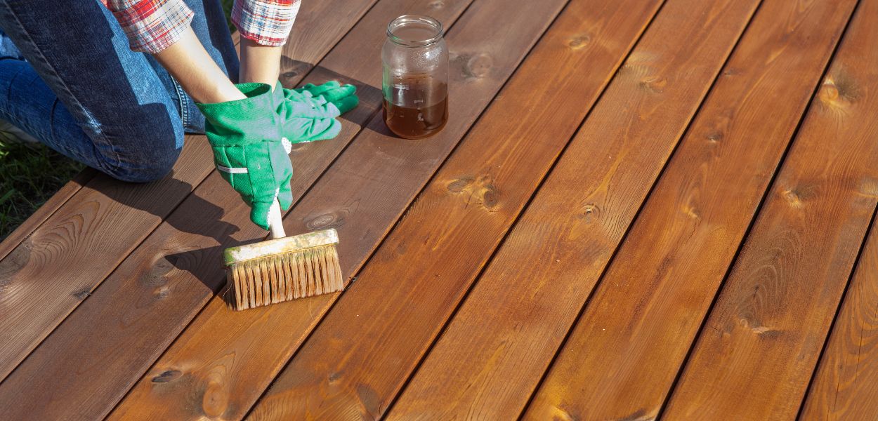 Treating timber decking with brush