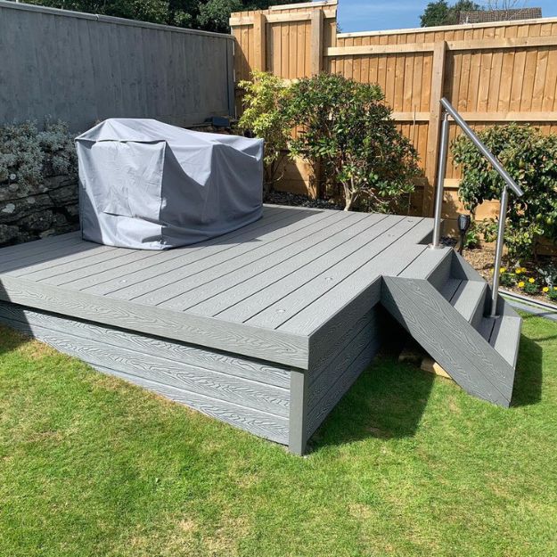 Raised level decking with steps and handrail