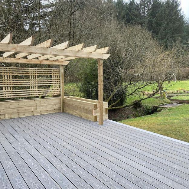 stone grey decking with pergola on steep slope