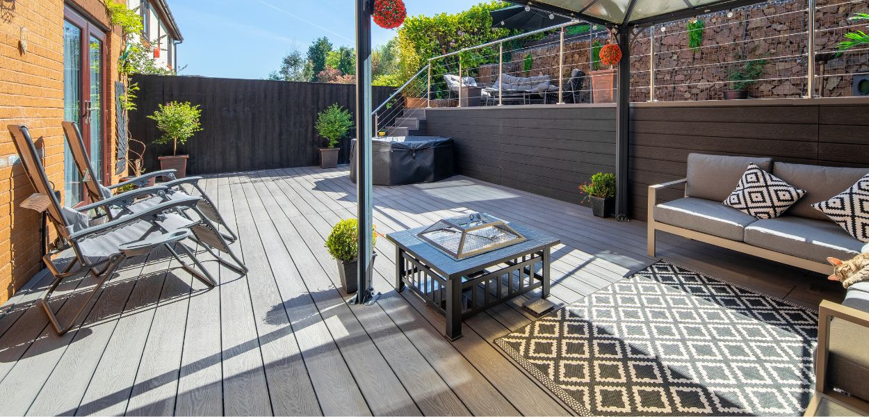 Outdoor patio area with Cladco Woodgrain Stone Grey Composite Decking.