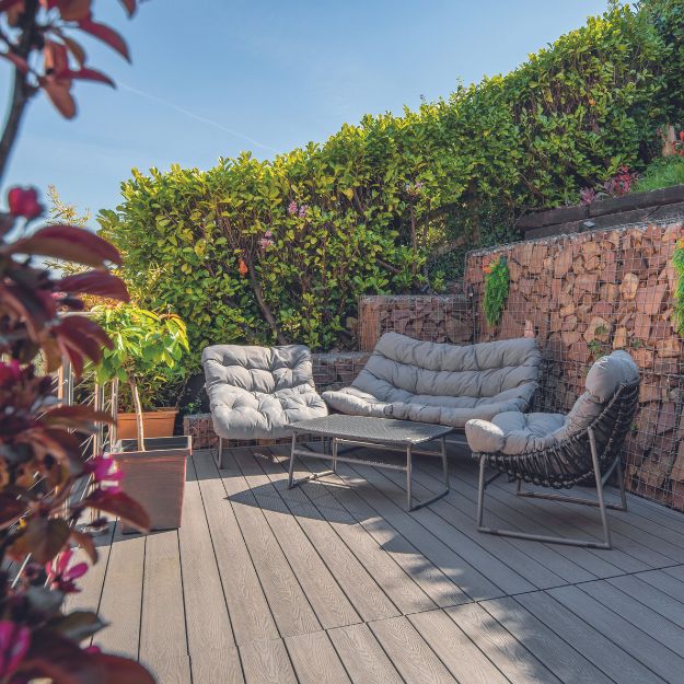 Outdoor area with Cladco Woodgrain Composite Decking in Stone Grey.