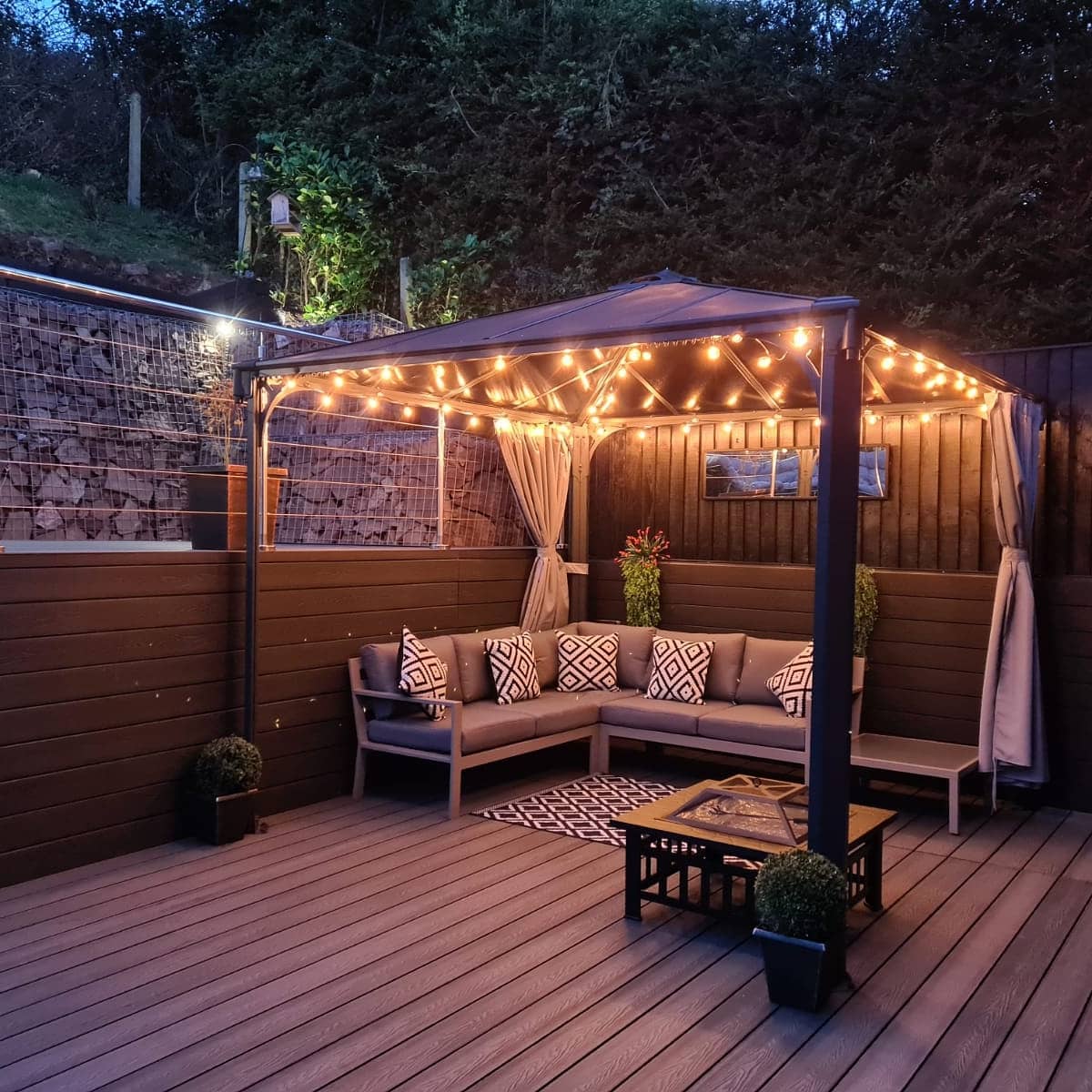 Evening outdoor patio area with Cladco Woodgrain Stone Grey Composite Decking.