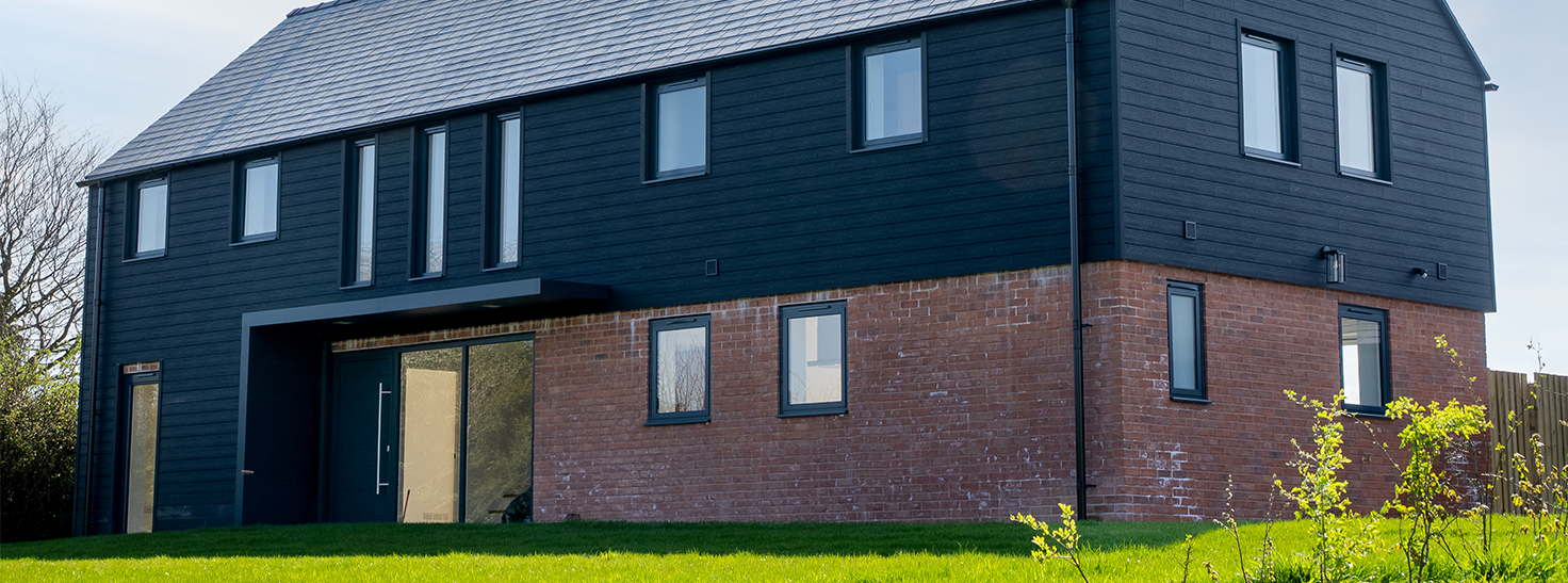 Home featuring Cladco Signature Composite Wall Cladding with contrasting red brick base and sleek black-framed windows