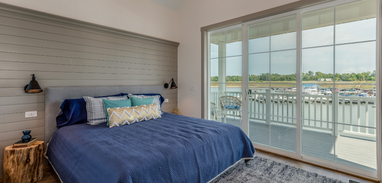 Floor to ceiling: shiplap wall panelling installed as a feature wall/headboard in this coastal bedroom