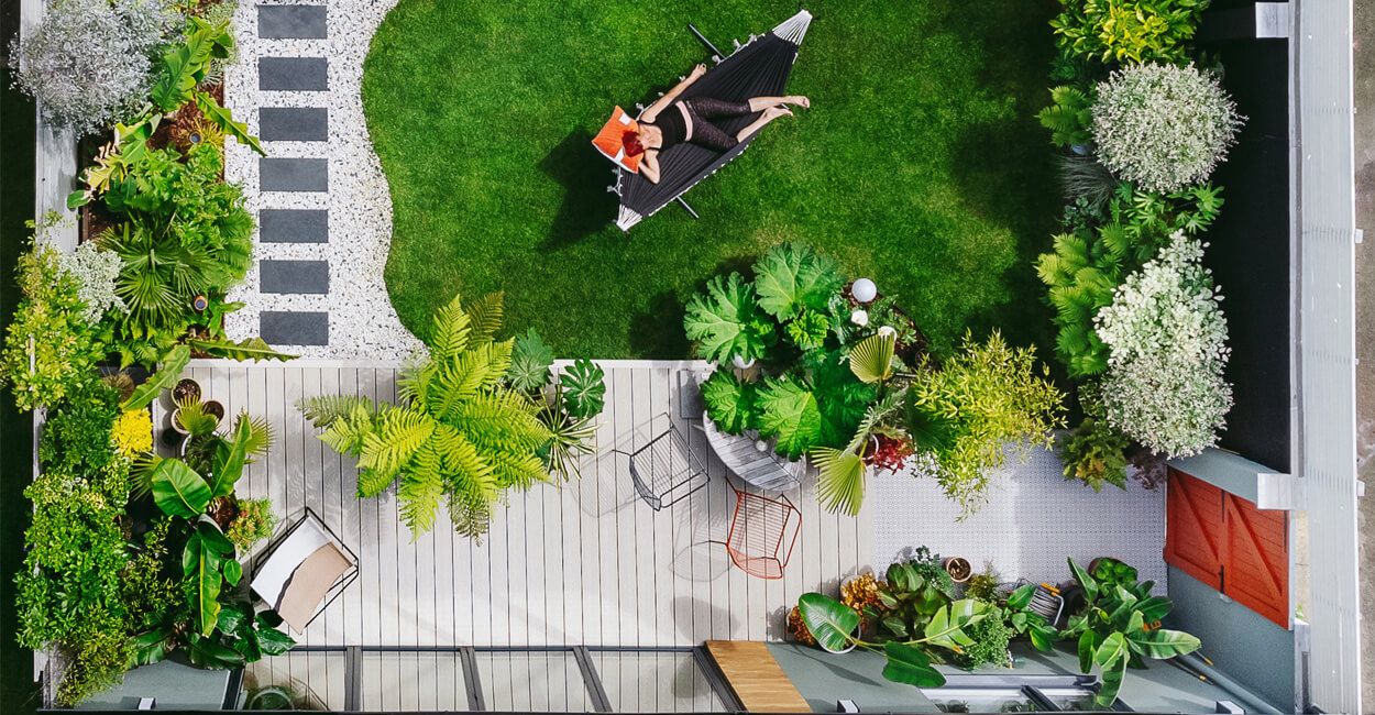 birds eye view of a garden with decking and a hammock
