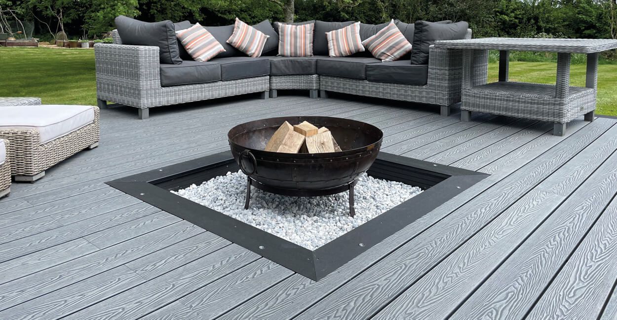 Picture frame effect: Stone Grey Woodgrain Composite Decking with a Bullnose Board Centrepiece for a firepit