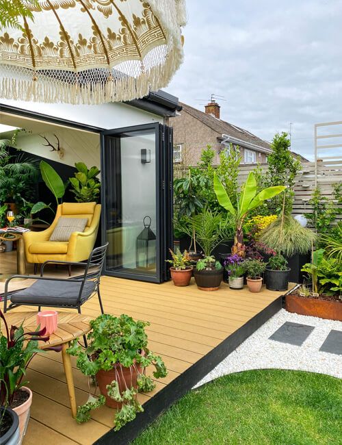 teak decking in a garden with lots of potted plants