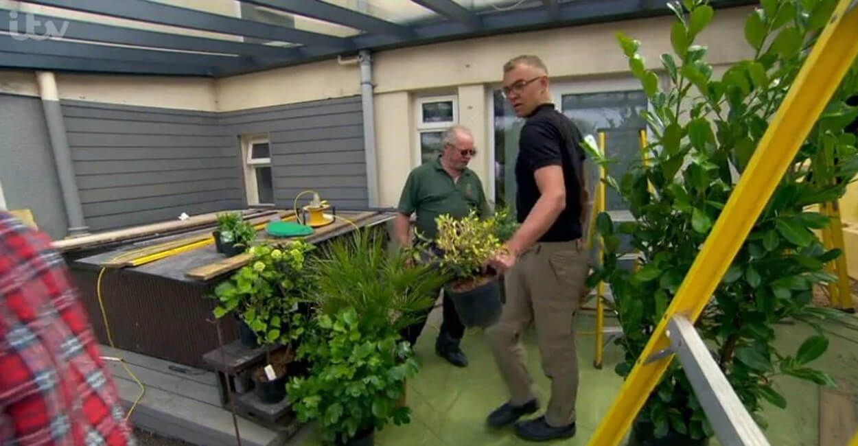 Two men arranging plants ready place in the garden