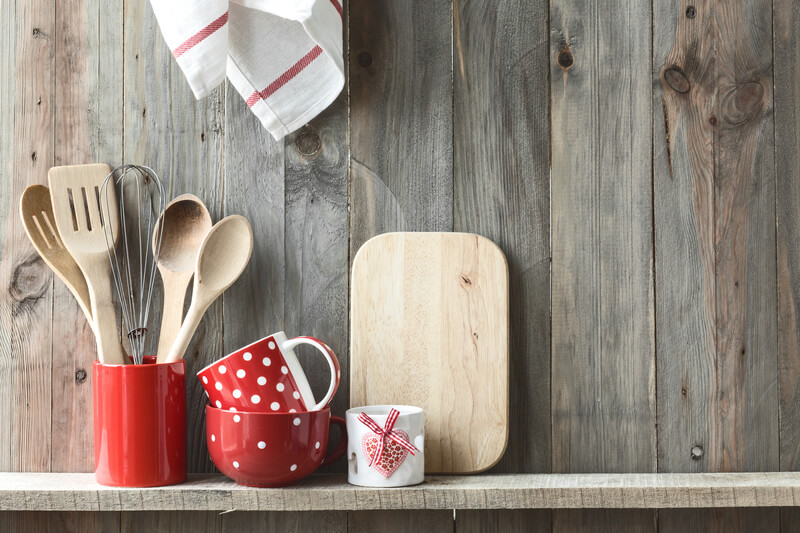 Kitchen utensils and cup on shelf